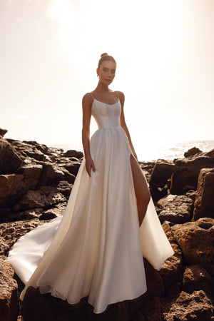 Alya bridal dress made of matte satin with a corset top and thin straps, offering minimalist elegance from the front.