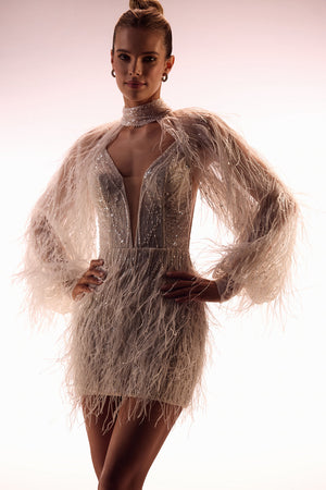 Viva bolero – long-sleeved blush lace bolero with feather-like tassels, studio photo.