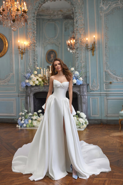 Alizee wedding dress from the Something Blue 2027 collection – a folded strapless neckline and draped satin skirt.
