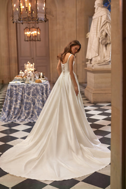 Aretuza wedding dress from the Something Blue 2027 collection – a clean square neckline, slender straps and full satin skirt.