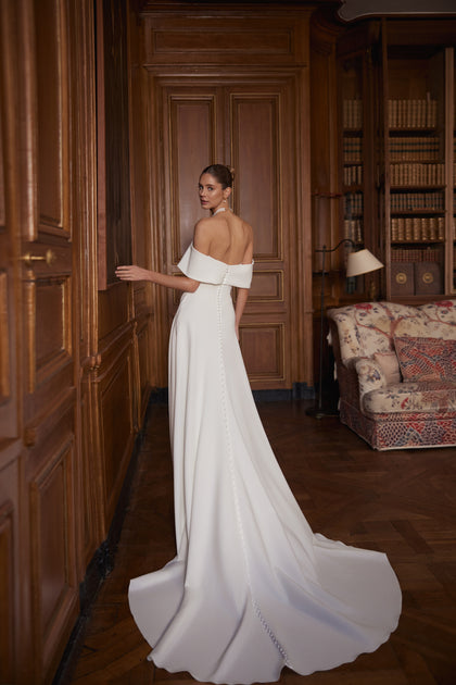 Calliope wedding dress – a wide off-the-shoulder neckline and clean satin skirt with a slit, DAMA Couture Something Blue 2027.