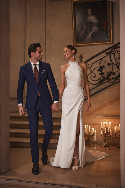 Camilla wedding dress from the Something Blue 2027 collection – a pearl-embellished halter collar, wrap draping and thigh-high slit.