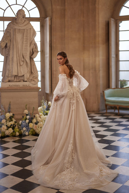 Celestine wedding dress – an open neckline, airy off-the-shoulder sleeves and 3D florals.