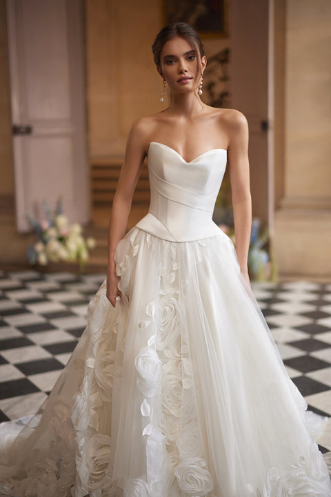 Cornellia corset + skirt – A-line bridal gown with an asymmetrically draped corset and voluminous layered skirt.