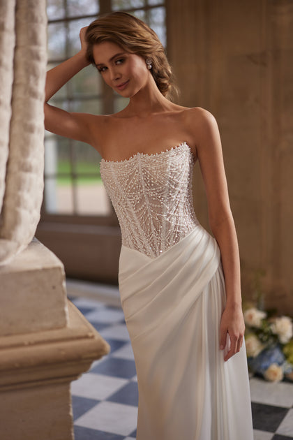 Greta wedding dress – a richly beaded strapless corset and draped satin skirt.