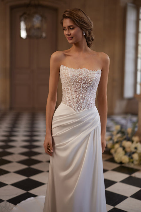 Greta wedding dress – a richly beaded strapless corset and draped satin skirt, DAMA Couture Something Blue 2027.