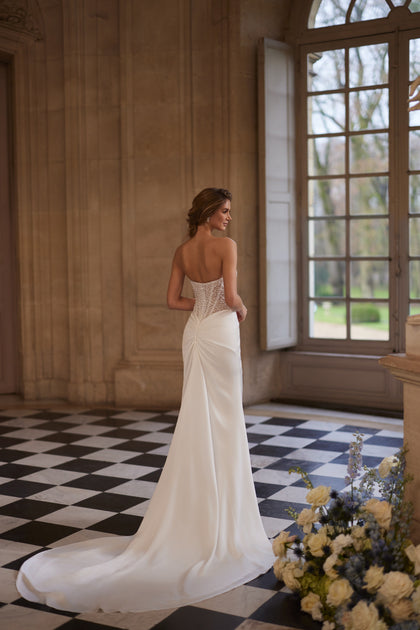 Greta wedding dress from the Something Blue 2027 collection – a richly beaded strapless corset and draped satin skirt.