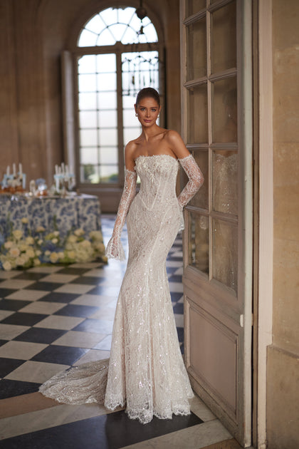 Irulian wedding dress – a strapless shimmering bodice and fitted lace silhouette.