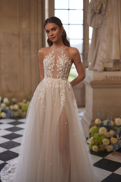 Nilla wedding dress – a sheer high neckline and floral lace tulle skirt.