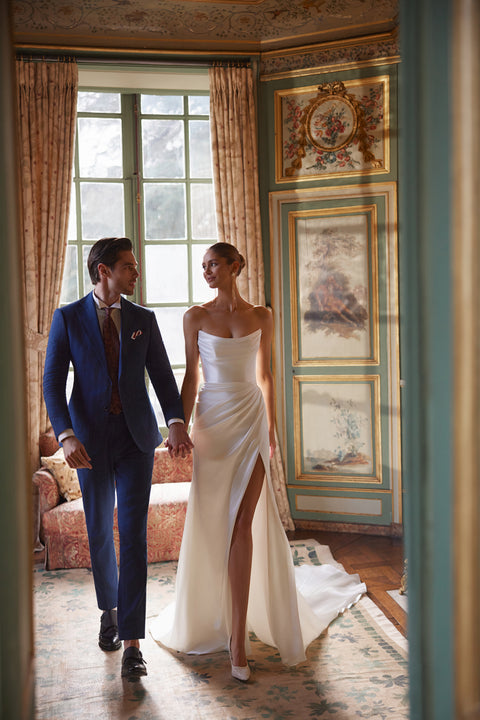 Sodden wedding dress – mermaid bridal gown with a softly draped strapless neckline and high slit in fluid satin.