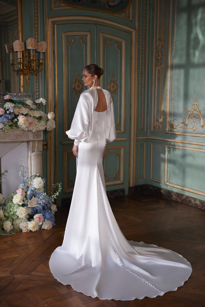Sodden wedding dress from the Something Blue 2027 collection – a softly draped strapless neckline and high slit in fluid satin.