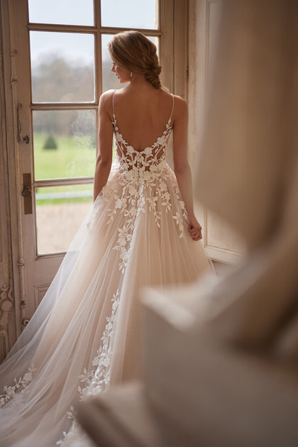 Solene wedding dress from the Something Blue 2027 collection – delicate straps, an open neckline and floral lace appliqués.