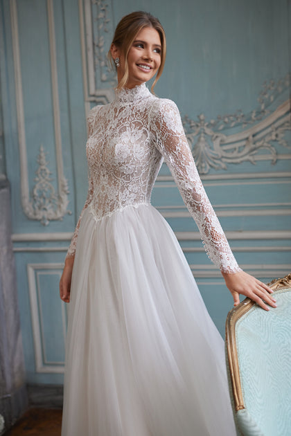 Tonia wedding dress – a high neckline and long sheer lace sleeves, DAMA Couture Something Blue 2027.