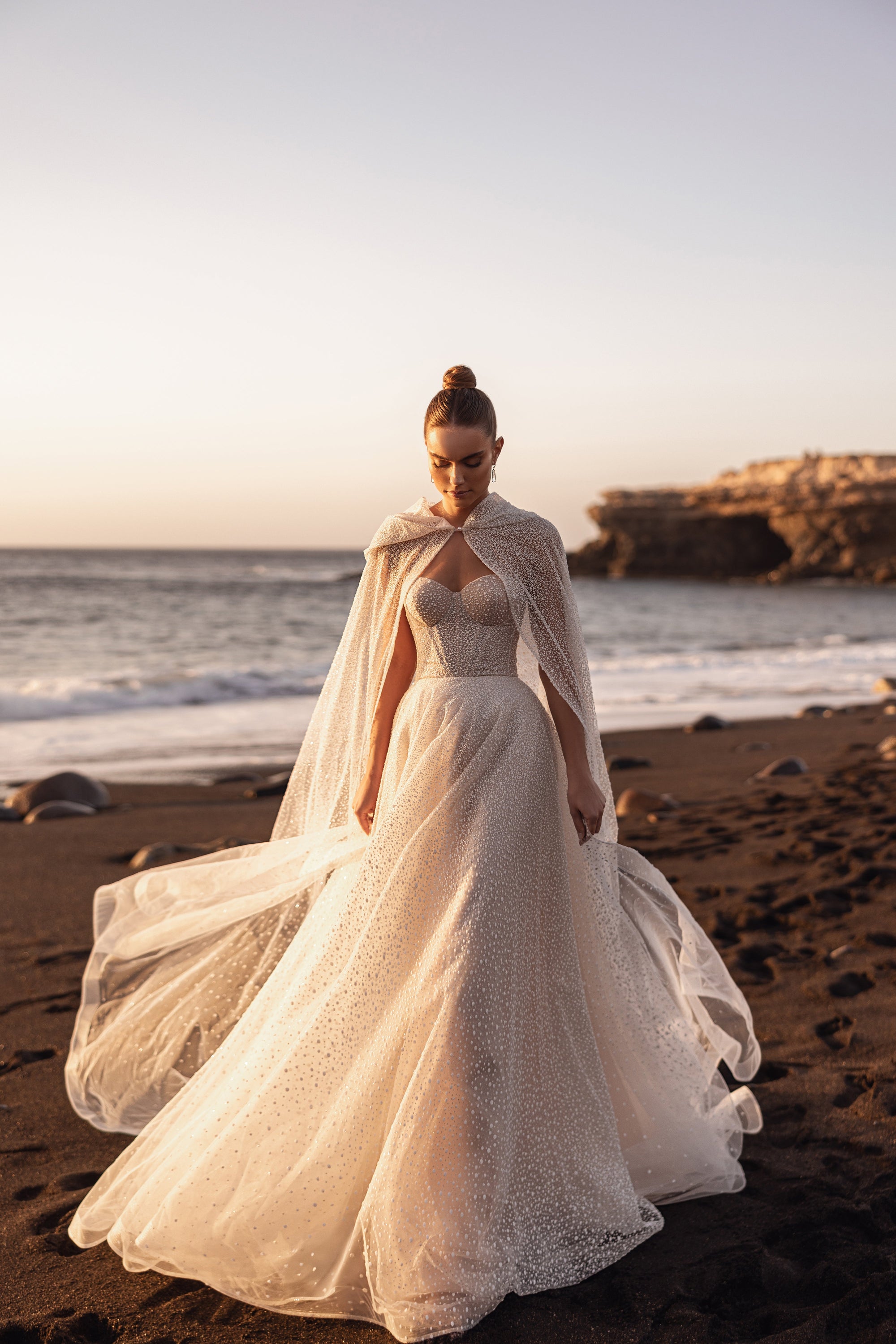 Amira bridal cape paired with a strapless corset wedding dress for a fairytale bridal look.