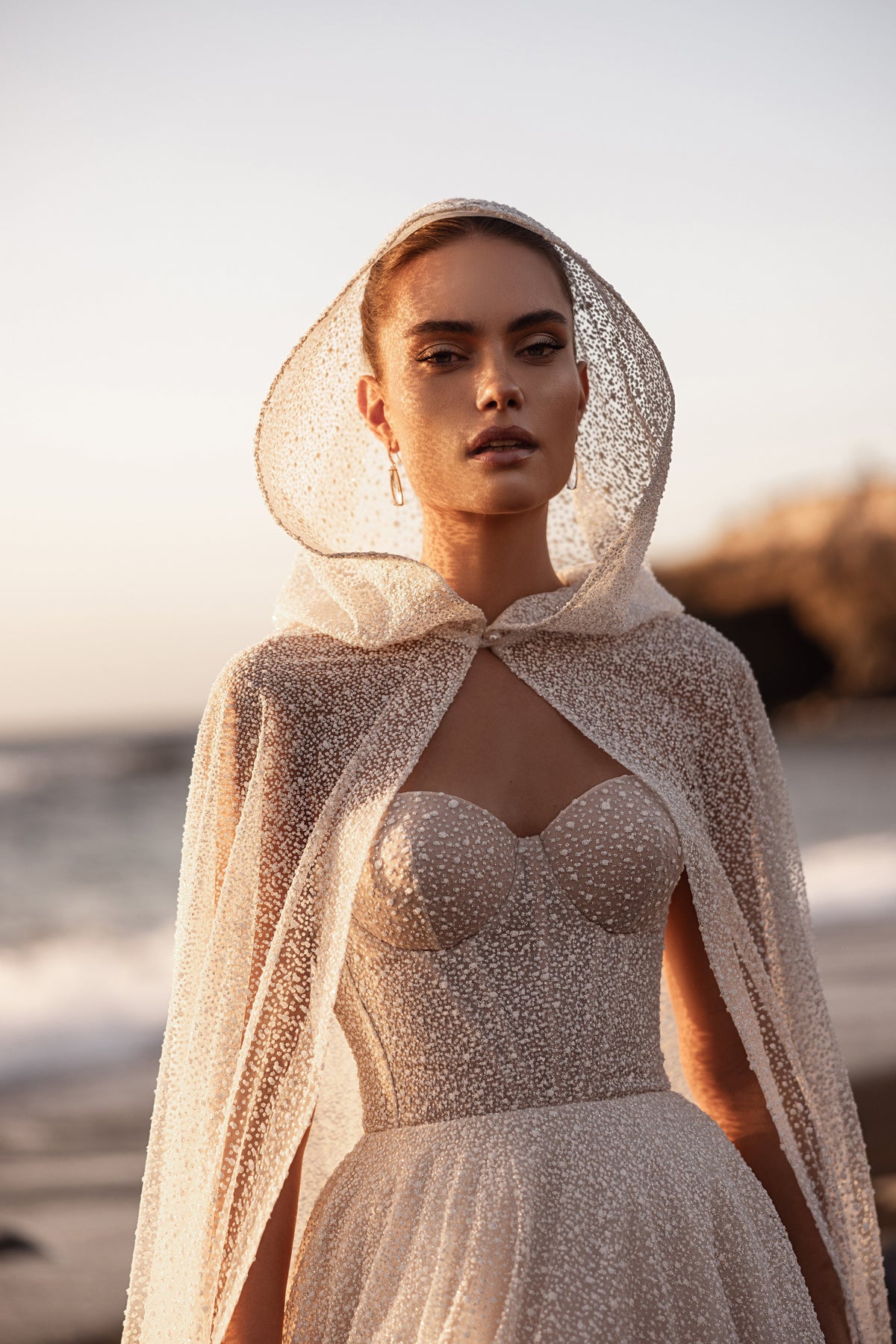 Amira bridal cape with a delicate hood and couture-inspired embellished tulle.