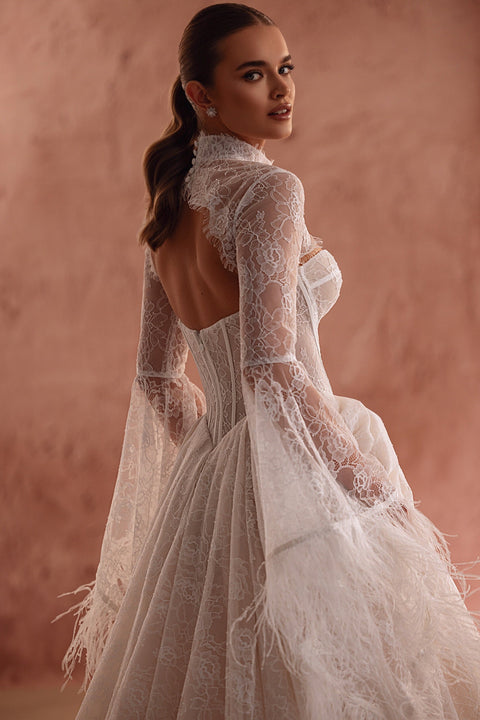 The Michelle bridal lace bolero with long sleeves in haute couture style adds a unique touch to the bridal look.
