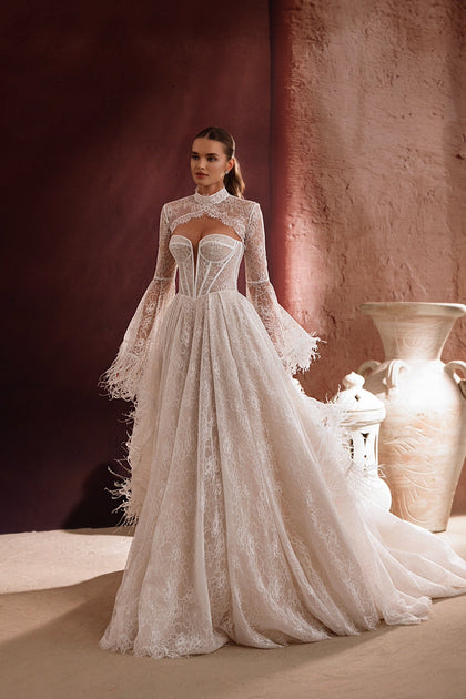 The back of the Michelle wedding dress from the Zahra al-Sahra collection features a long lace train and feather details for a luxurious, fairy-tale bridal look.