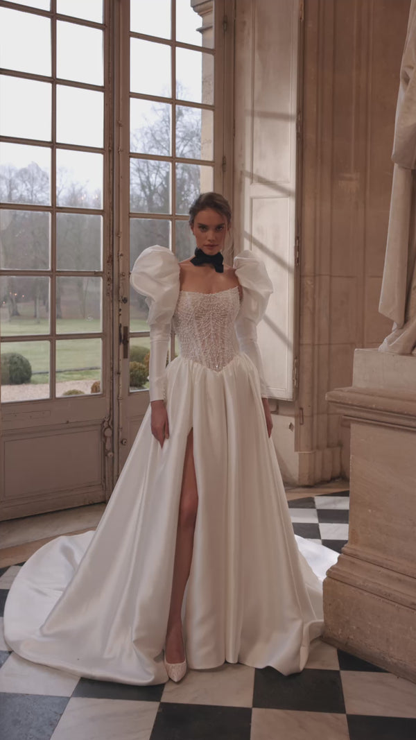 Video of the Aliette wedding dress in motion – A-line silhouette with a crystal-embellished corset and voluminous sleeves.