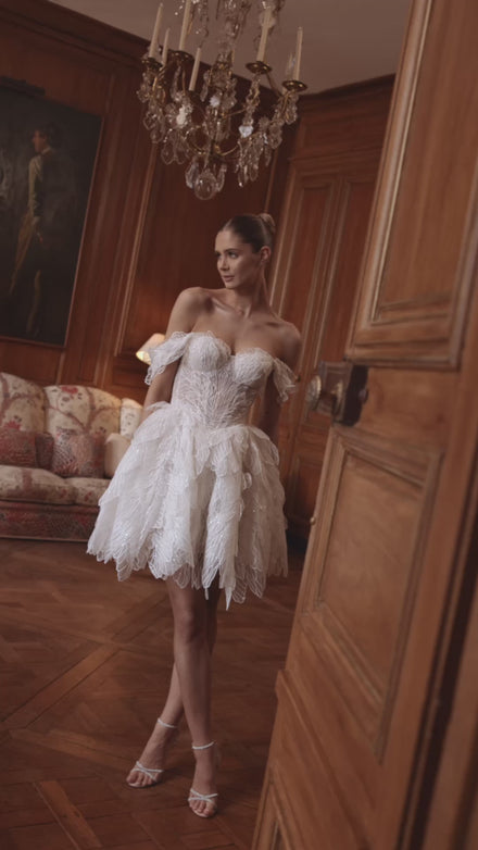 Video of the Tinkerbell wedding dress – a semi-sheer sweetheart corset and feathered skirt.