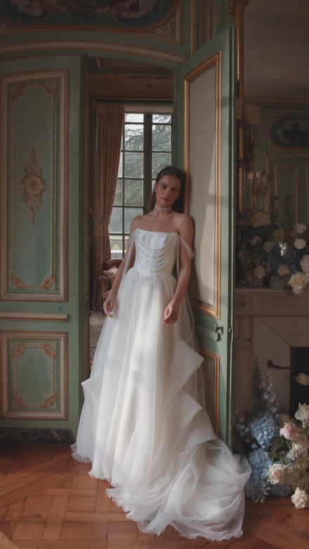 Video of the Nerina wedding dress in motion – A-line silhouette with jewellery-like detailing and off-the-shoulder tulle straps.