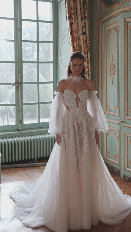 Video of the Melusine wedding dress in motion – A-line silhouette with a strapless botanical lace bodice and detachable tulle sleeves.