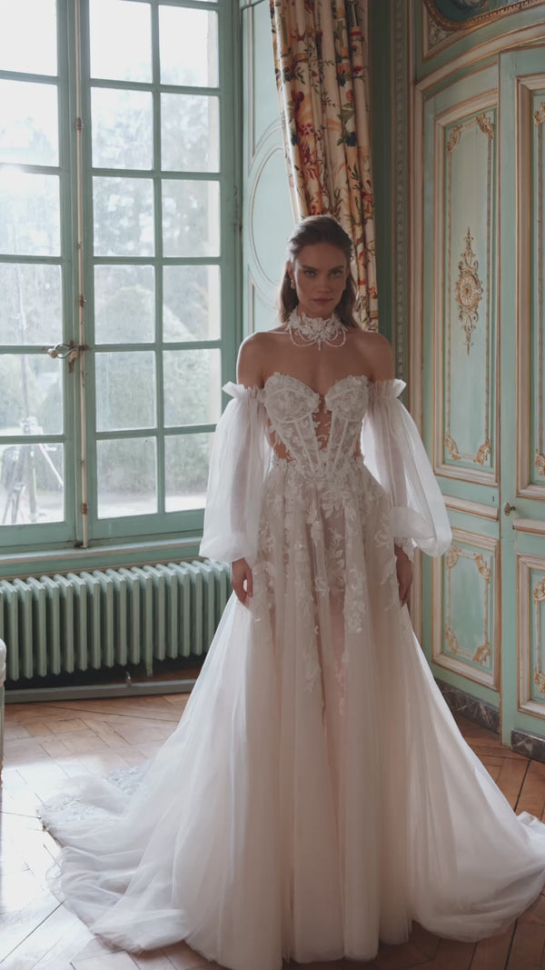 Video of the Melusine wedding dress in motion – A-line silhouette with a strapless botanical lace bodice and detachable tulle sleeves.