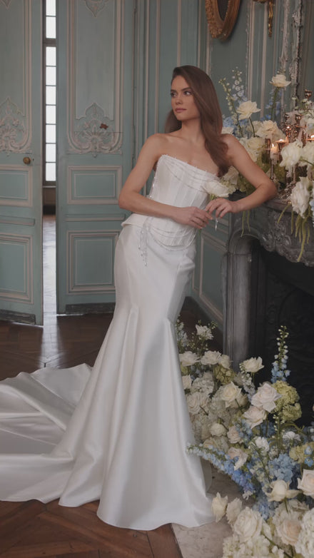 Video of the Armance wedding dress in motion – A-line silhouette with a corset bodice draped with strands of pearls.