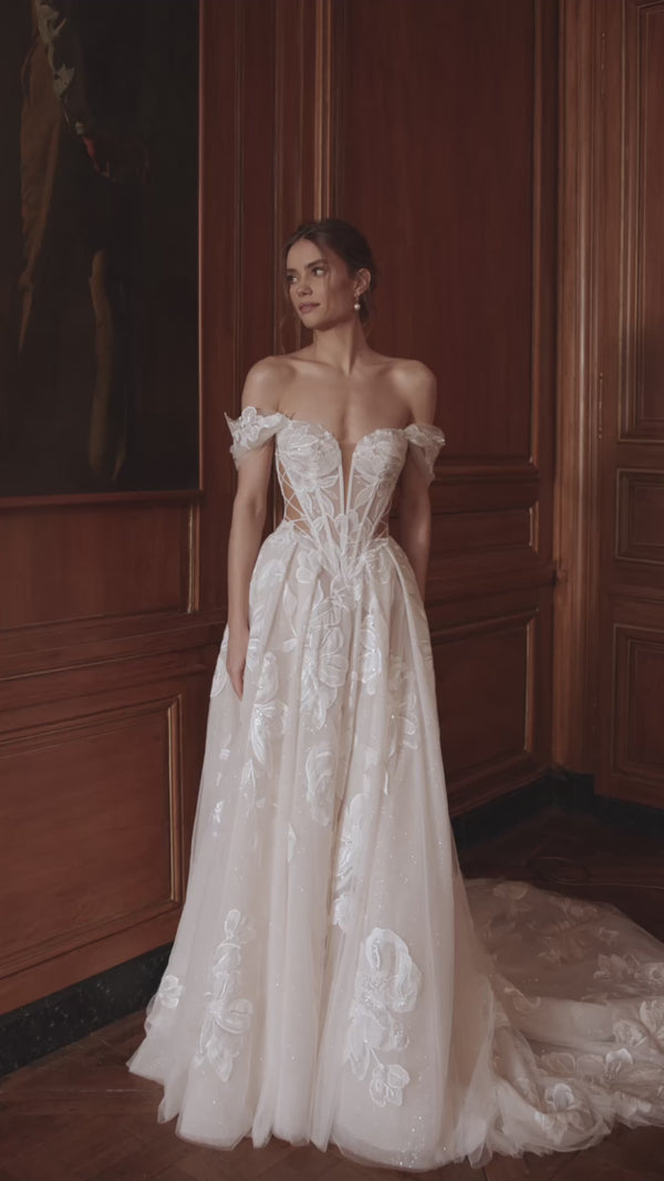 Video of the Vespera wedding dress in motion – A-line silhouette with an off-the-shoulder corset with a plunging neckline and sheer boning.