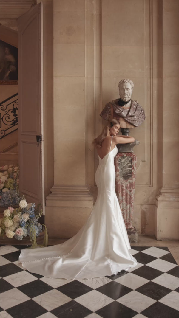 Video of the Josephin wedding dress in motion – mermaid silhouette with a deep V neckline and open back in fluid satin.