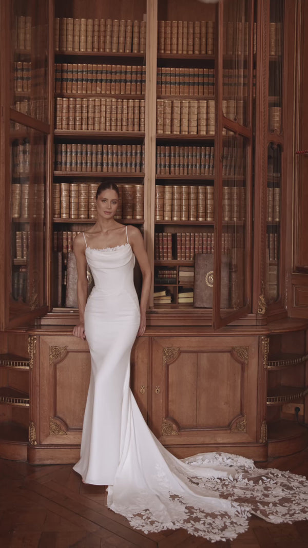 Video of the Valerie wedding dress in motion – mermaid silhouette with spaghetti straps and a softly draped cowl neckline.