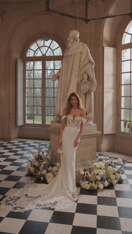 Video of the Matilde wedding dress in motion – mermaid silhouette with an off-the-shoulder neckline and lace-traced fitted silhouette.