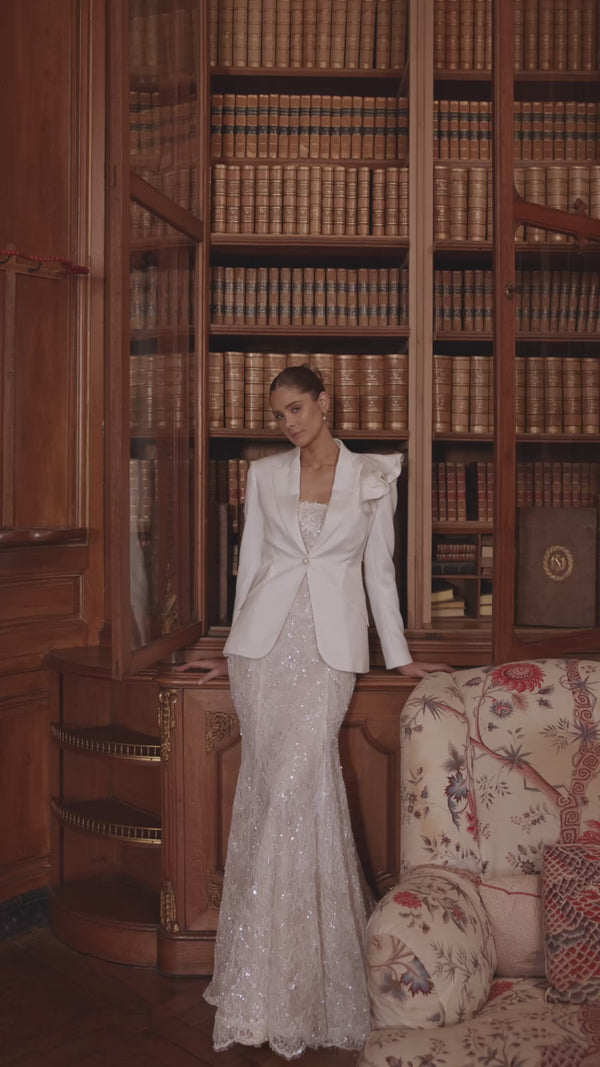 Video of the Irulian wedding dress in motion – mermaid silhouette with a strapless shimmering bodice and fitted lace silhouette.