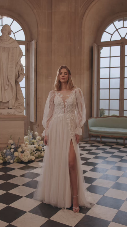 Video of the Blair wedding dress in motion – A-line silhouette with a sheer floral bodice and airy voluminous sleeves.
