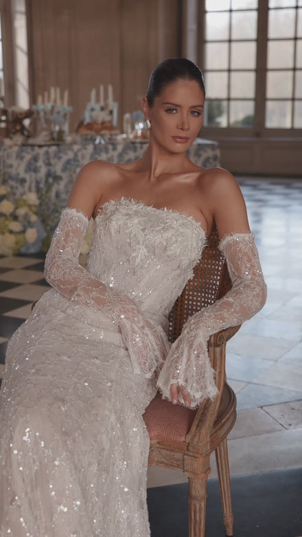 Video of the Irulian wedding dress – a strapless shimmering bodice and fitted lace silhouette.