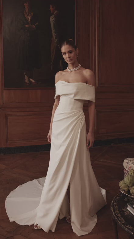 Video of the Calliope wedding dress in motion – A-line silhouette with a wide off-the-shoulder neckline and clean satin skirt with a slit.
